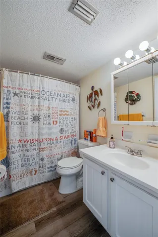 Charming full bathroom with mirrored vanity with ample lighting, and a tub/shower combo for everyday comfort.