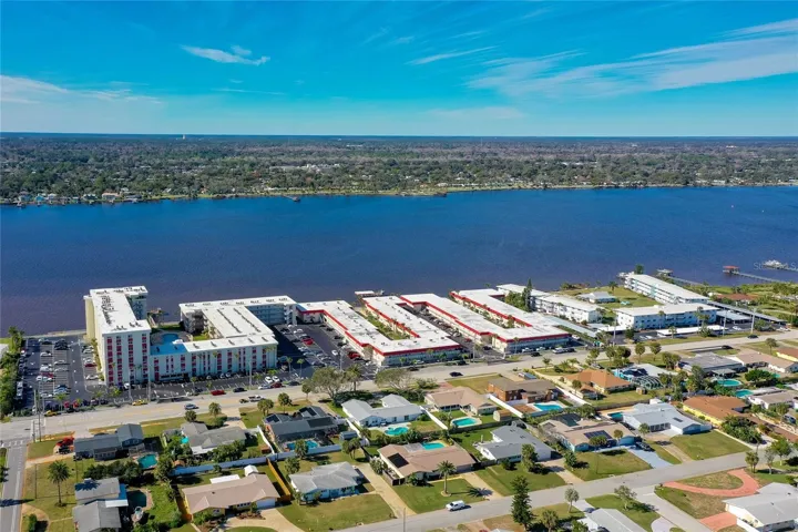 Full view of the entire condo complex along the Halifax River, with easy access to scenic walking paths and public parks.