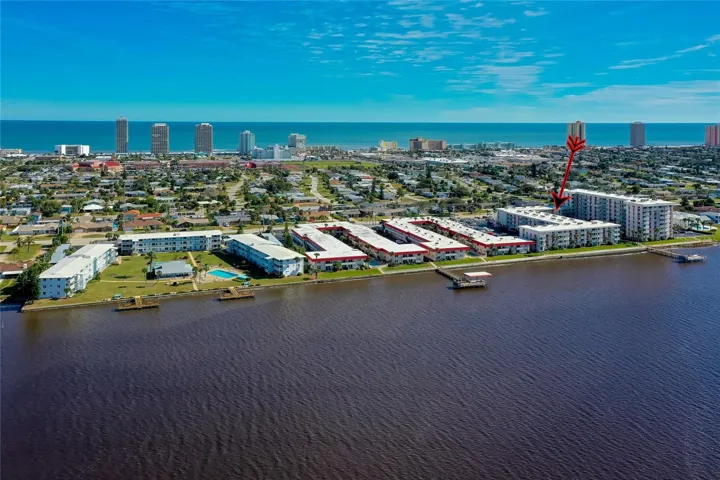 This elevated angle emphasizes the building’s riverfront location and direct access to the community dock.