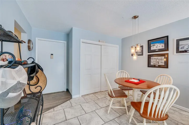 Cozy dining space adjacent to the kitchen and wall space for artwork or décor.