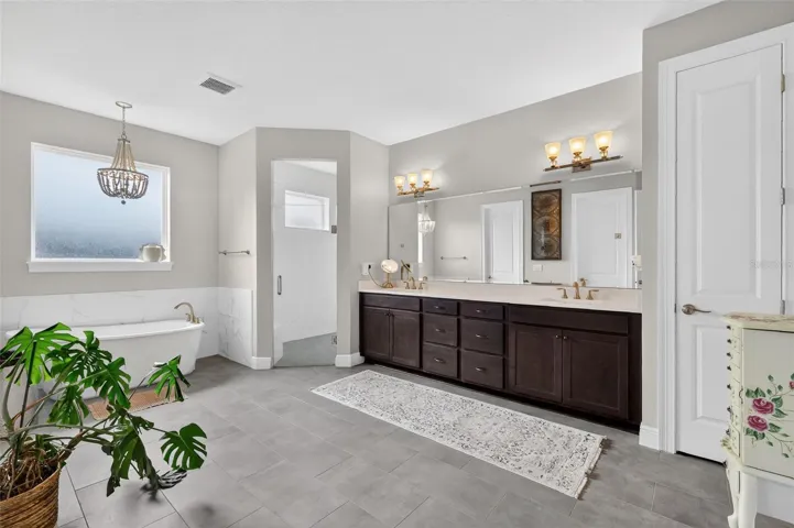 Master bathroom with dual sinks and soaker tub