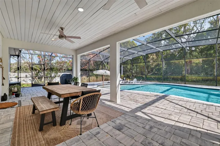 Enjoy this beautiful pool deck with pavers and board and batten ceiling
