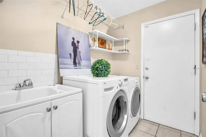 Large laundry room with utility sink between the main living & 2-car garage~