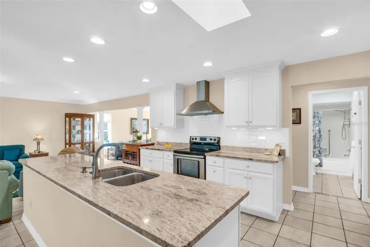 Sleek stainless appliances, recessed lighting, and a large skylight allowing for loads of natural light~