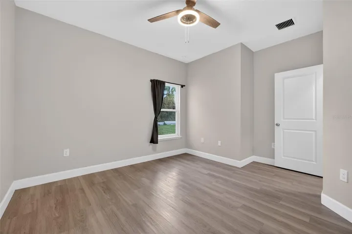 Master Bedroom- Ceiling Fan, Vinyl Floors and Double Pane Window