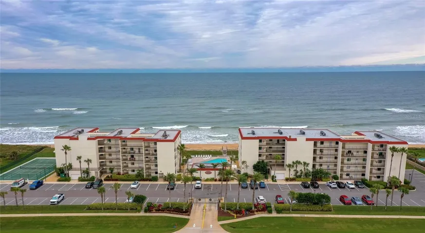 This beautifully maintained oceanfront community features two mid-rise buildings, a central pool area, and tennis courts—all nestled along the coast with panoramic Atlantic views.