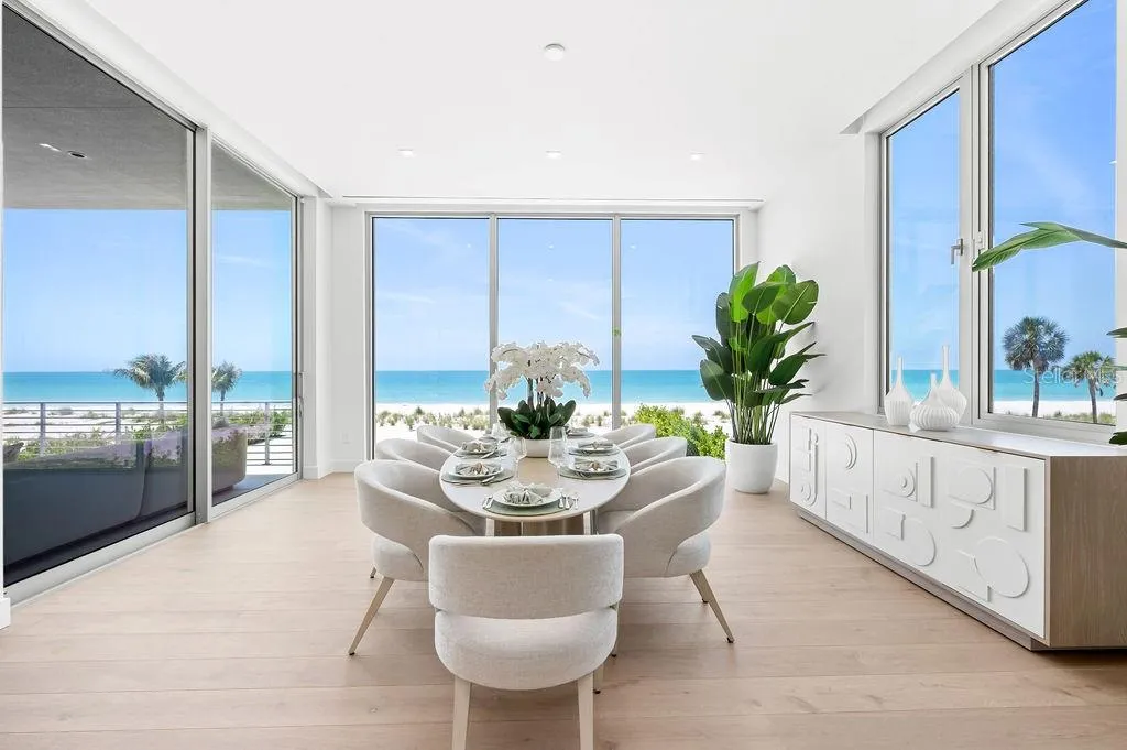 Dining area is surrounded by 11 foot impact glass windows and sliders