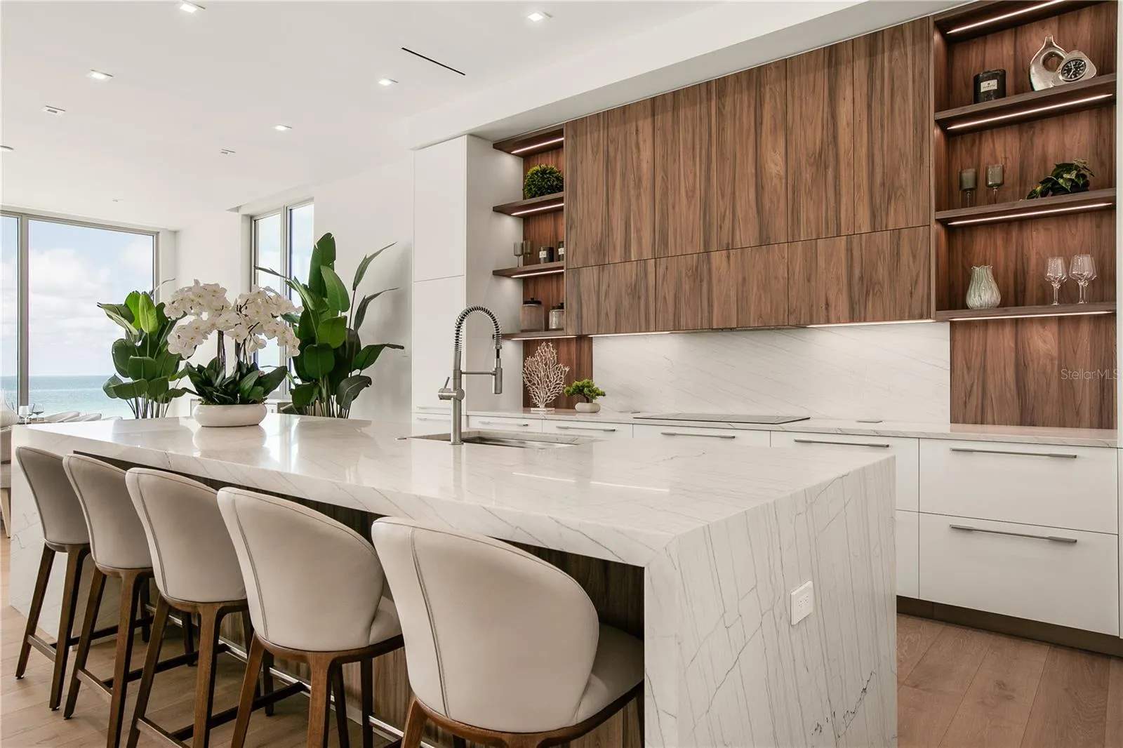 The oversized Quartzite waterfall island seats 5.