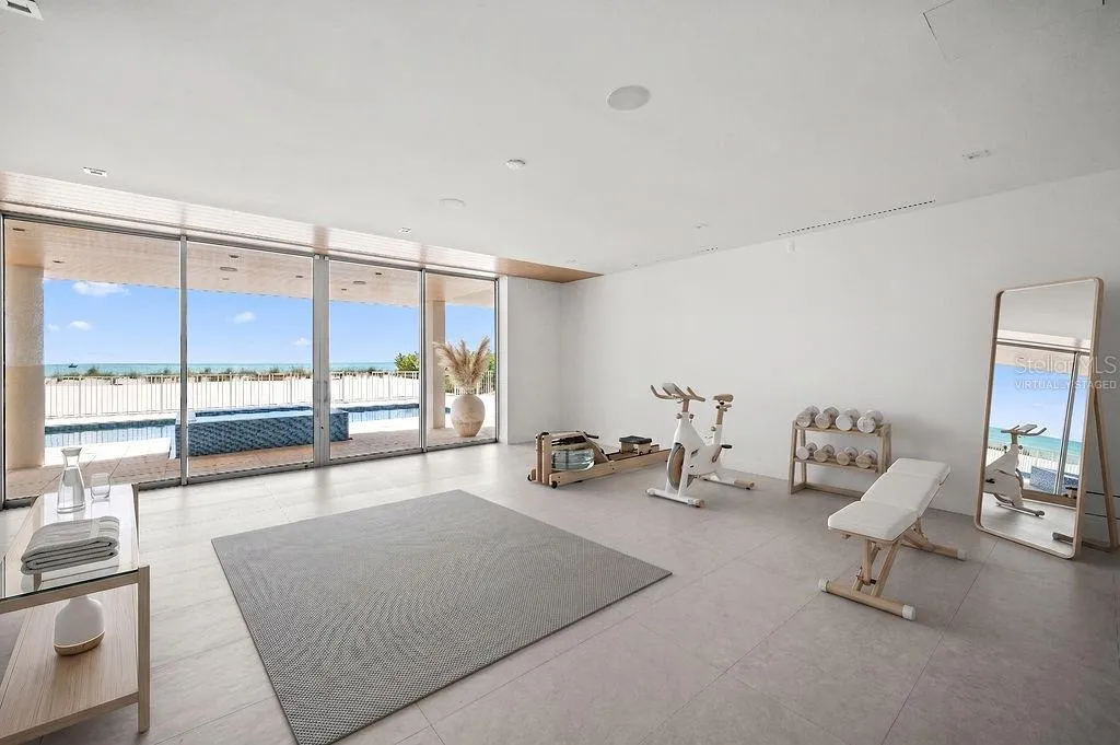Virtually staged flex space on first floor is under air and overlooks the pool, spa and private beach