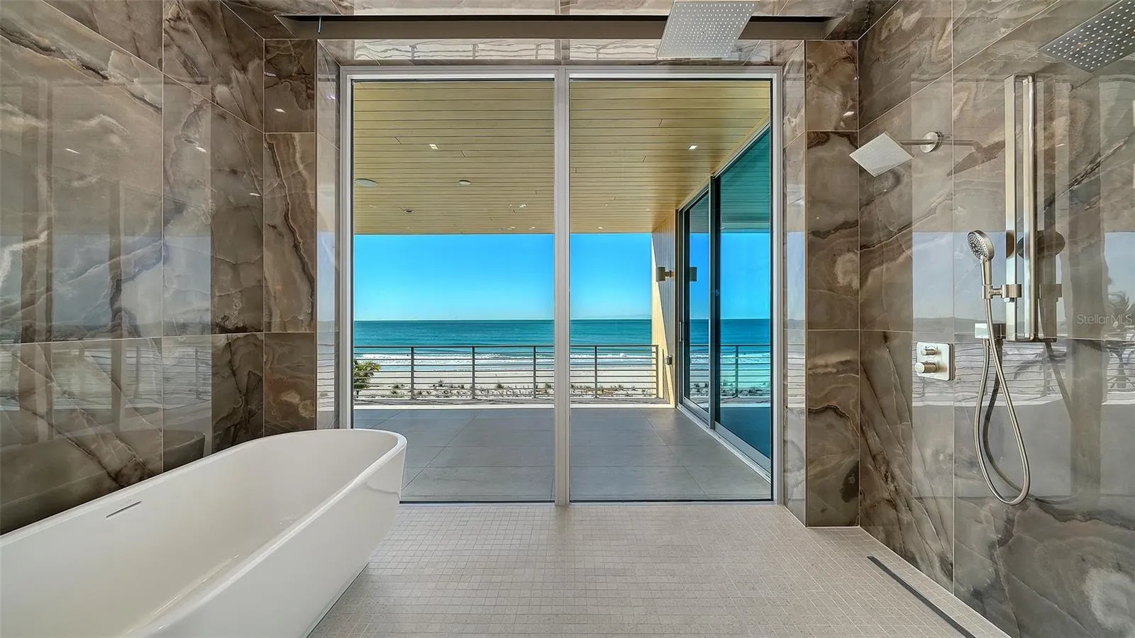 Primary Bathroom features wet room with Hansgroghe™ and Axor™ plumbing fixtures