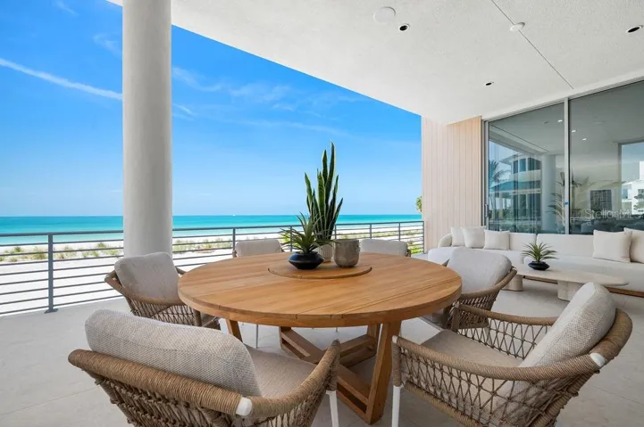 Main floor terrace highlights 40 feet of outdoor living space featuring Longboard™ accents to compliment to azure blue Gulf