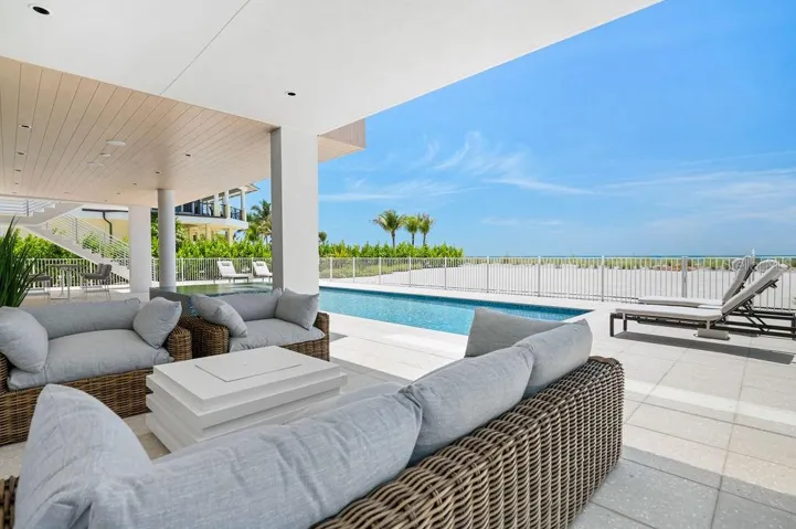 Covered seating area near the Spa and Pool provides shade and sweeping Gulf views
