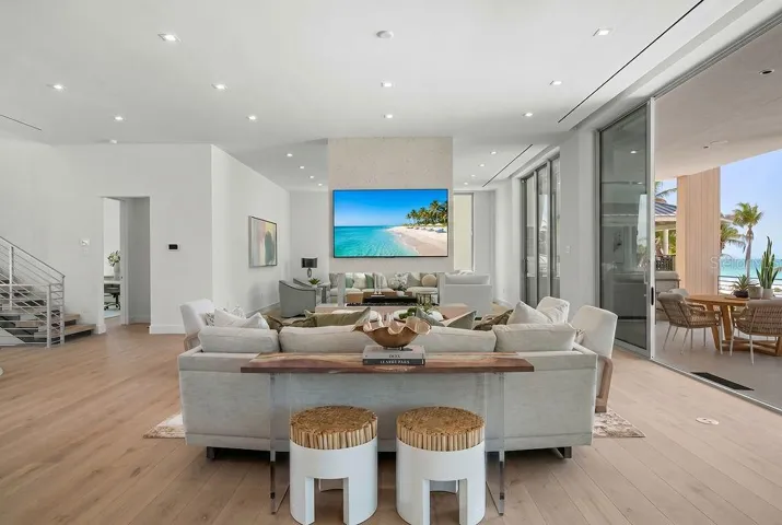 The open floor plan is surrounded by 11 and 10 foot Floor-to-ceiling Premium ES Insulated Sliders with sweeping Gulf views