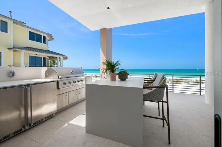 Enjoy the Summer kitchen with Coyote™ gas grill, refridgerator and sink.