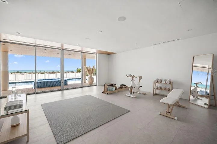 Virtually staged flex space on first floor is under air and overlooks the pool, spa and private beach