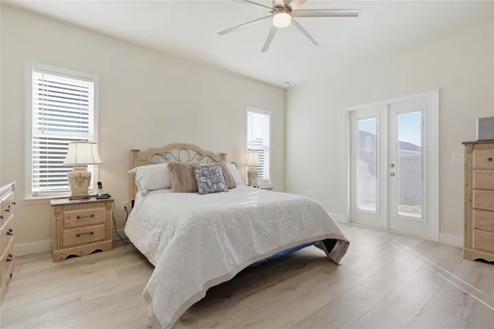Primary bedroom has doors to covered patio