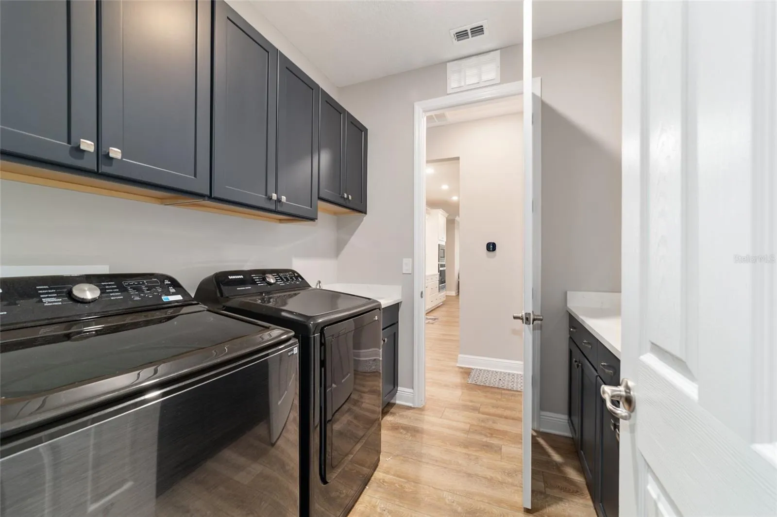 laundry room open to the primary closet