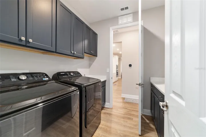 laundry room open to the primary closet