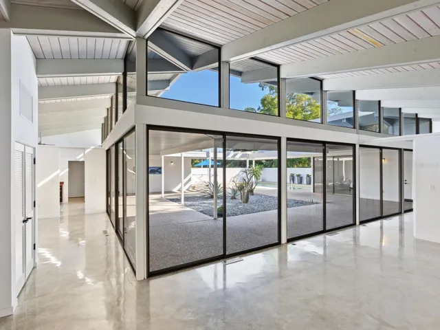 Dramatic view from inside front entry with dining room and kitchen to left, living rooms + two bedrooms to the right
