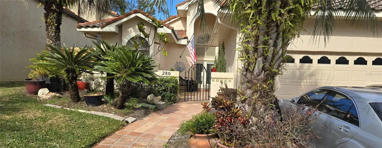 Beautiful mature trees of frontal view of 4 bedroom 3 bath home