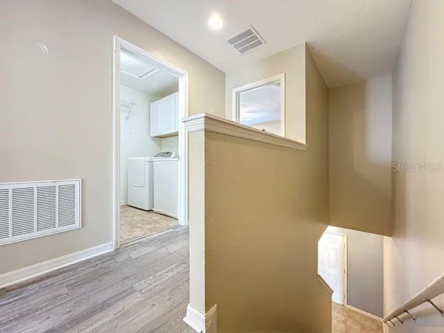 hallway featuring new flooring