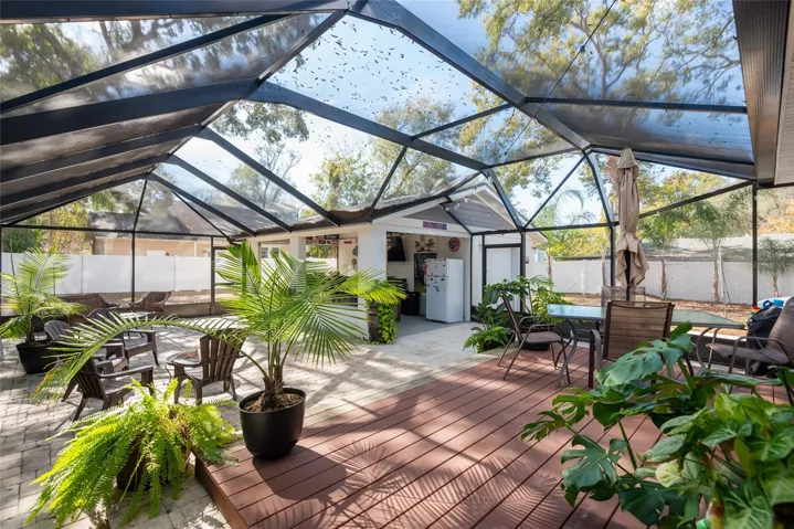 Back deck flows into patio, with built-in covered bar, refrigerator, plumbed, great for entertaining