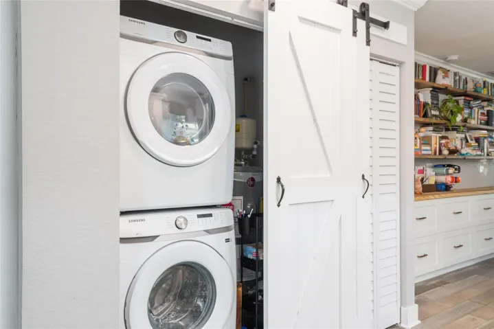 Washer and dryer are behind barn doors in kitchen