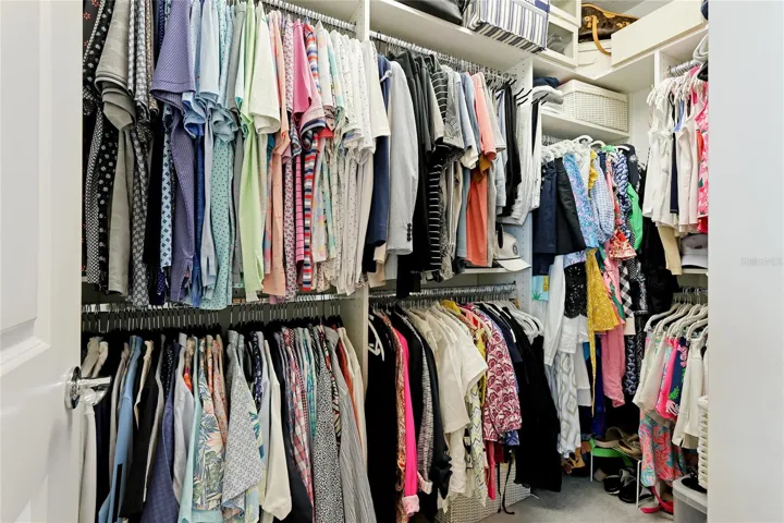 owner suite closet with custom shelving