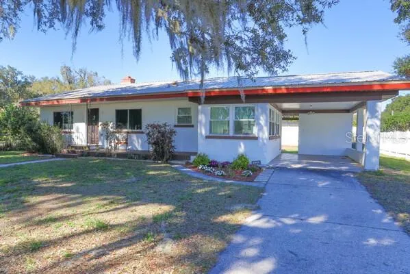 Front of the home. One car carport.