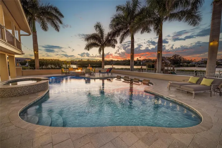 Propane gas heated salt chlorinated pool and spillover spa and firepit with a waterfall feature.  Yard is fenced.