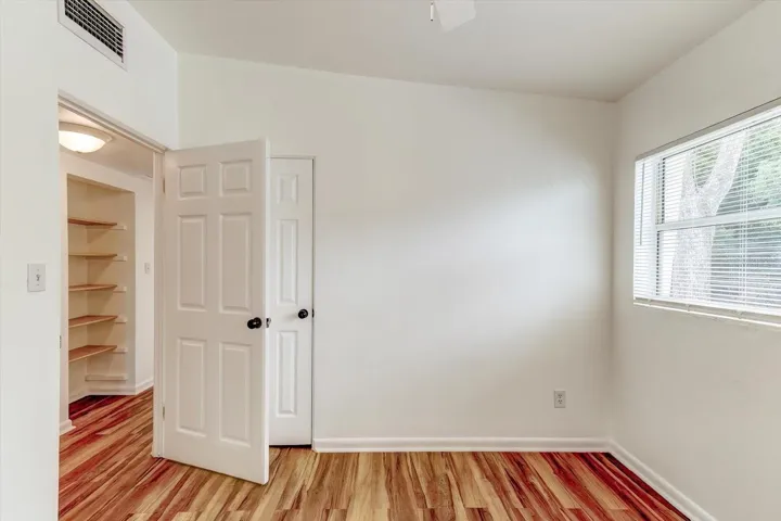 Bedroom 1 with view of hallway.