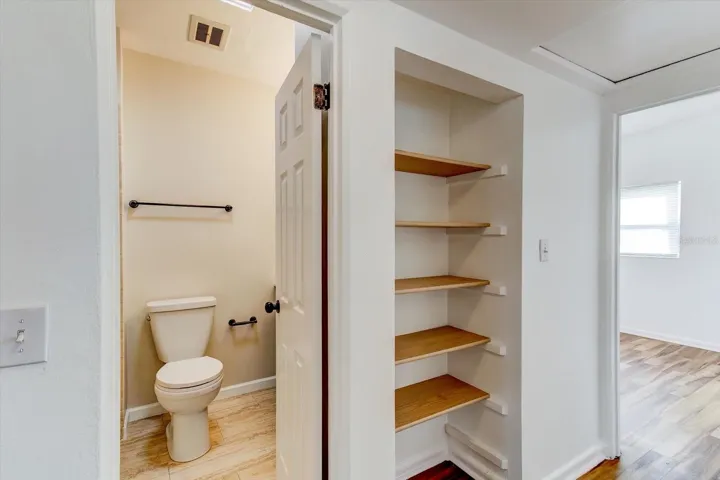 Hallway storage and view of guest bathroom.
