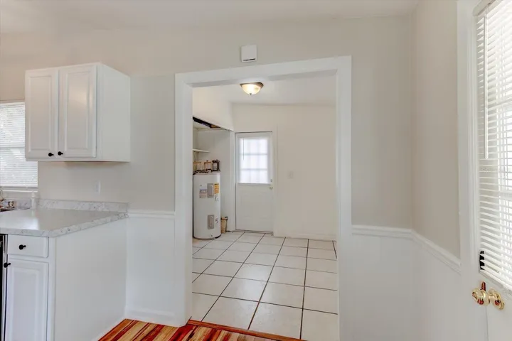 Indoor laundry room with additional storage area.