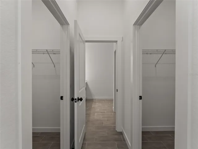 Primary bedroom hallway into bathroom