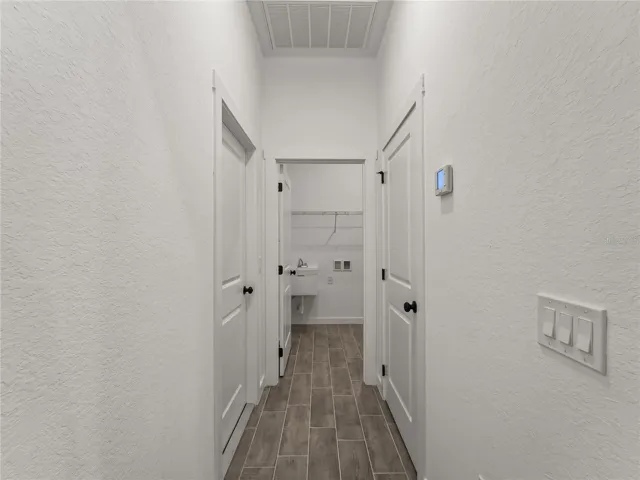 Hallway to interior laundry and garage