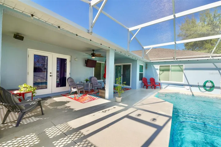 French Doors to Primary bedroom and other access points of home. Making the pool area a central feature of the home.