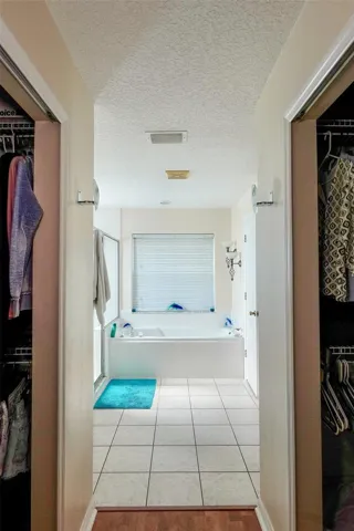 Primary Bathroom with his/ her walk in closets to sides