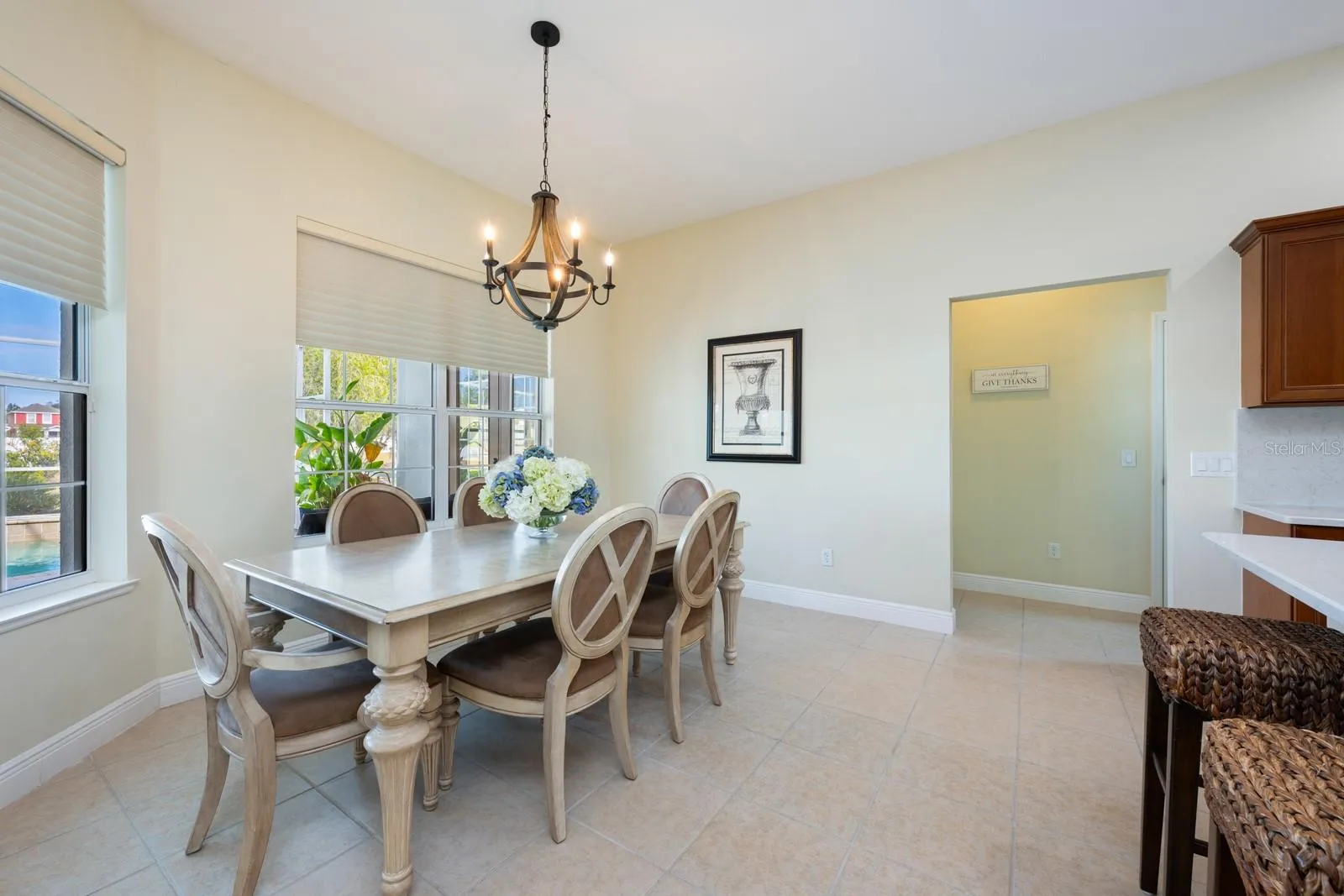 Light filled casual dining with a view of the pool.