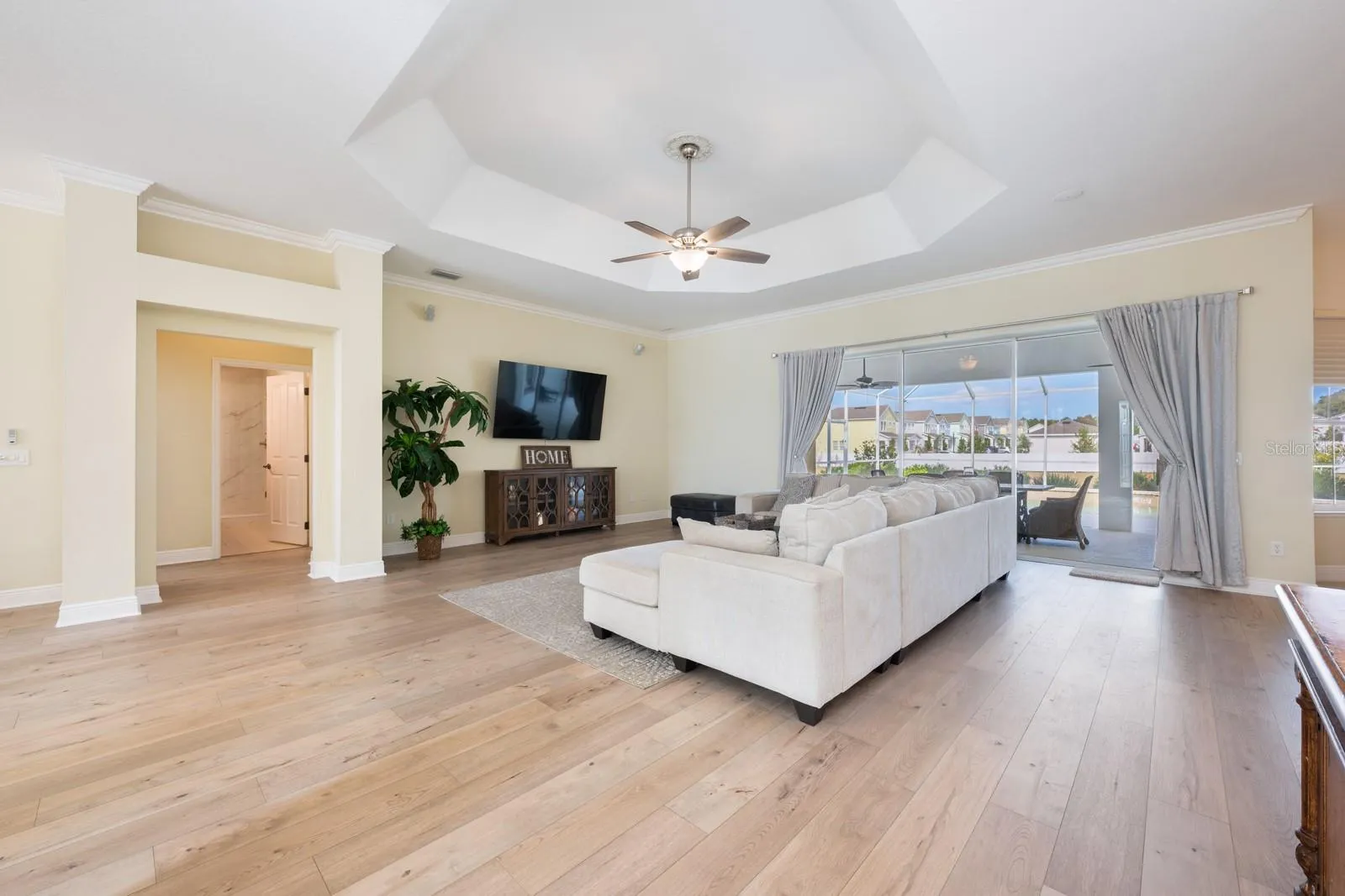 The open family room has a wall of sliding glass doors that let the natural light pour in.