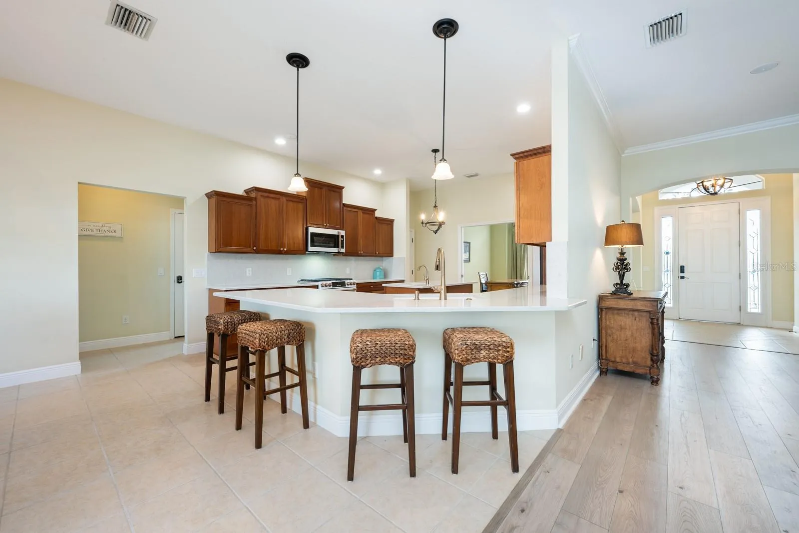 Inside, over 3,400 square feet of curated living space unfolds with high-end finishes, CERAMIC TILE and LUXURY VINYL PLANK FLOORING throughout, flexible formal areas, and an open, inviting family room that flows seamlessly into a light-filled breakfast nook and a timeless kitchen with a modern edge – perfect for any style!
