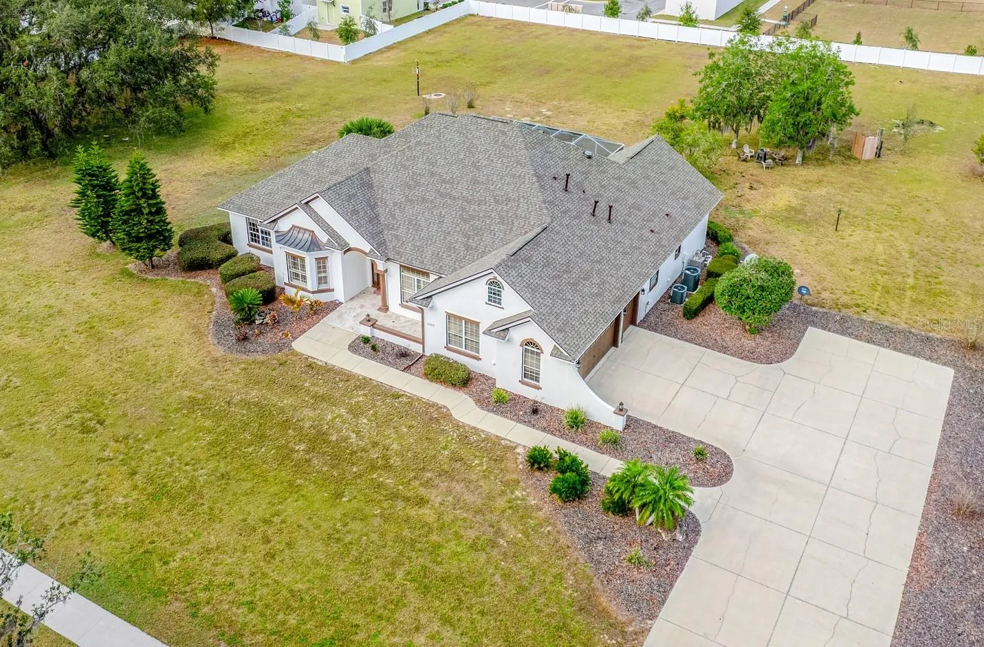 Set on two spacious lots totaling 2.28 ACRES, this one-of-a-kind ESTATE HOME in Wildwood delivers the rare combination of luxury, land, and freedom – NO HOA, golf-cart friendly, and just 2.2 miles from Brownwood Paddock Square in The Villages!
