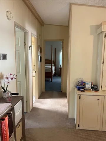 Hallway to 2nd bedroom and bathroom and primary bedroom.