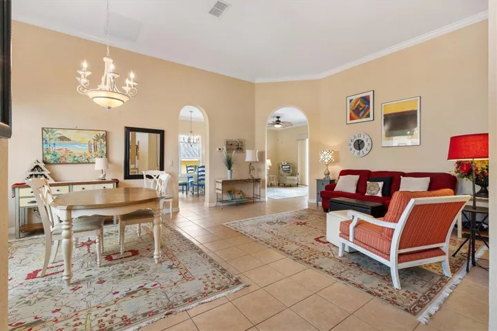 To left of foyer, dining room, formal living room, crown molding.  Through archway on left is kitchen and breakfast nook.  Through archway on right is the family room.