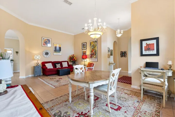 Dining room looking toward formal living room.  Archway on left leads to family room.  middle archway leads to guest bedroom and bath, archway on far right leads to den.