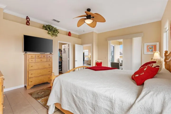 Primary en-suite with new sliding doors and windows in 2021.  Door to left of entry is the oversized walk-in closet.  Plant ledge.