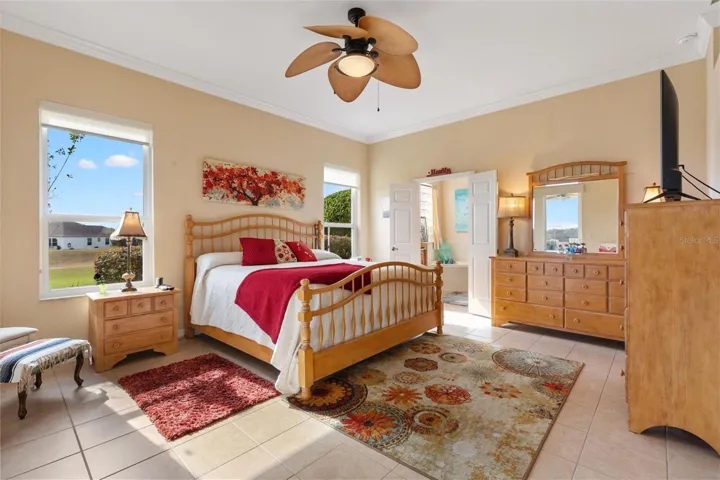 Primary en-suite with tile floors, crown molding, large walk-in closet with access from the bedroom, not bath.