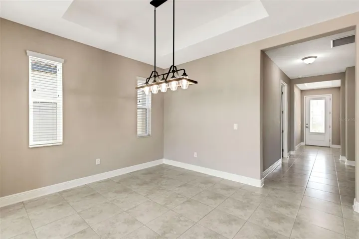 Main living spaces have crisp tray ceilings for added volume.