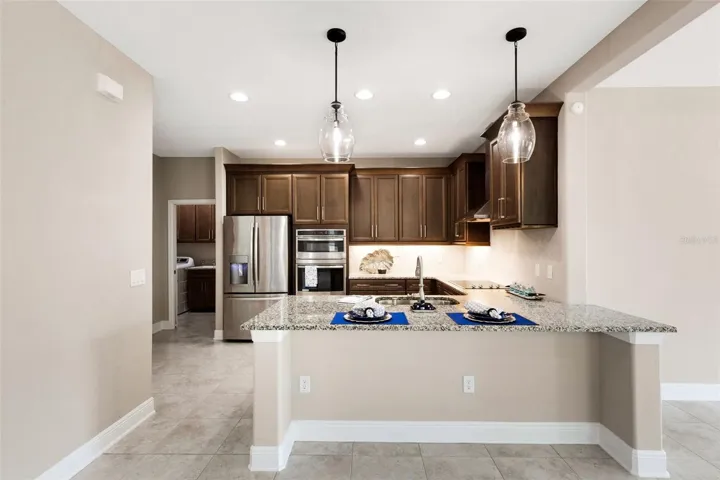 Spacious kitchen granite countertops, stainless appliances, built-in oven and microwave.