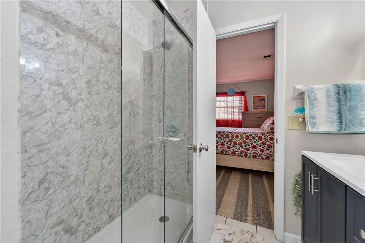 Luxurious spa shower with glass door and marble finishings