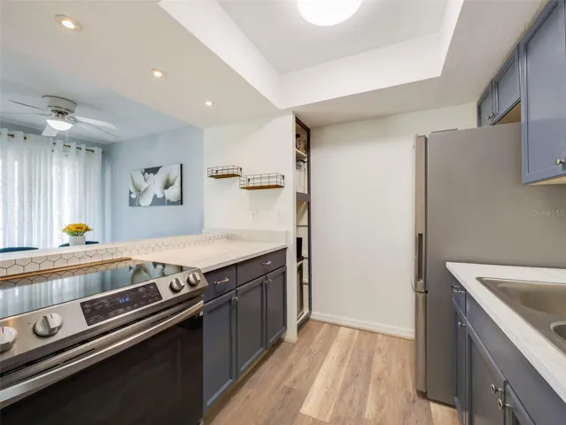 The Kitchen has been recently painted and features solid wood cabinetry, breakfast bar, NEWER STAINLESS STEEL APPLIANCES (2022) and a pantry closet, offering both style and functionality.